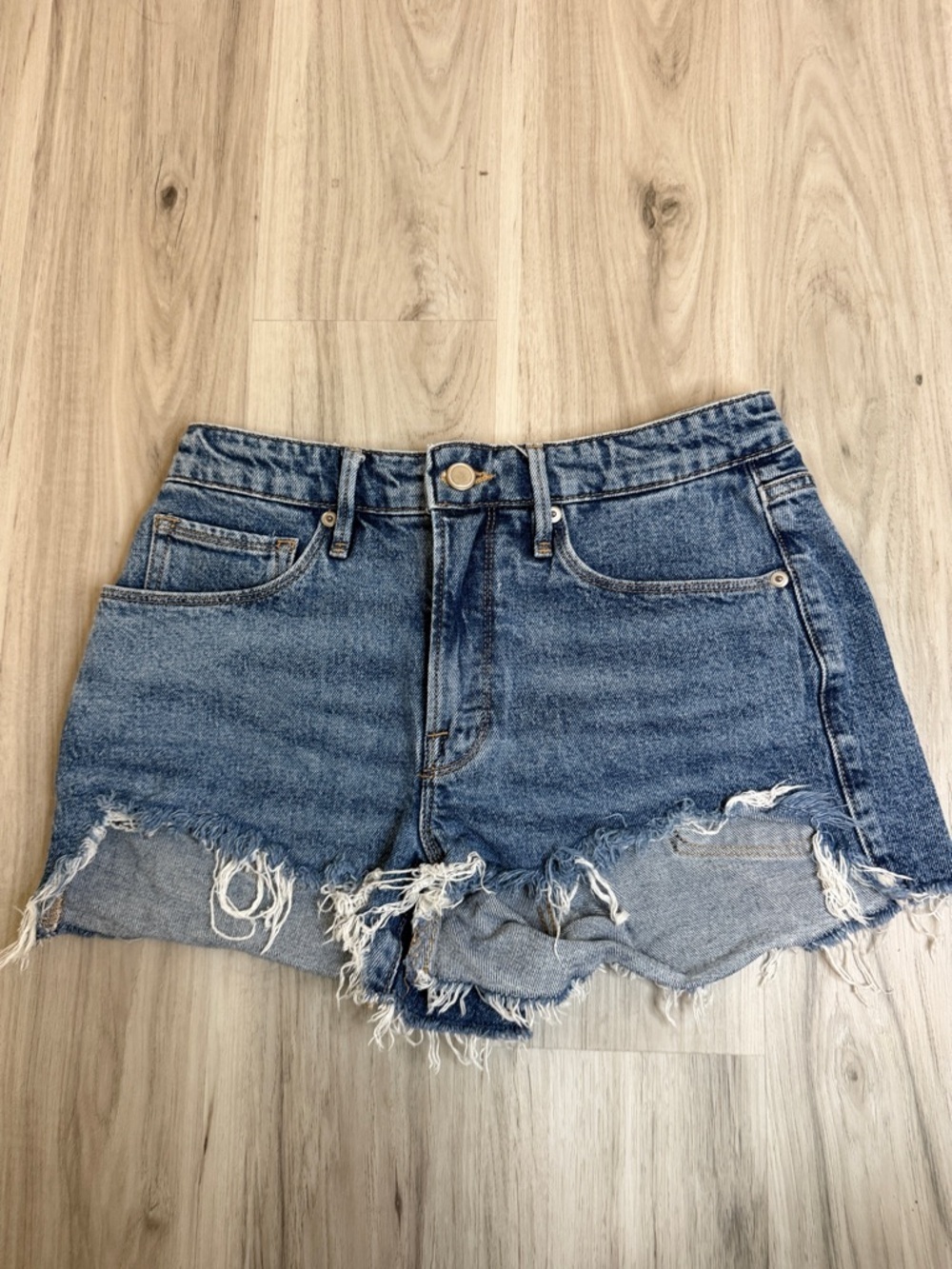 Good American Distressed Denim Shorts in Blue